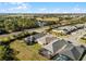 A view of the backyards and the community, with a lake and green space in the background at 5159 Twin Lakes Blvd, St Cloud, FL 34772