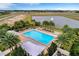 Aerial view of a pristine pool surrounded by lush palm trees and tranquil lake views at 5159 Twin Lakes Blvd, St Cloud, FL 34772