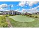 Putting green and lush landscaping in a manicured setting, with community buildings in the background at 5159 Twin Lakes Blvd, St Cloud, FL 34772