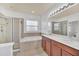 Main bathroom with dual vanity, a bathtub, a separate glass shower, and ceramic tile flooring at 591 Juniper Springs Dr, Groveland, FL 34736