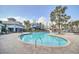 Community pool area featuring palm trees, lounge chairs, a water slide, and a clubhouse at 591 Juniper Springs Dr, Groveland, FL 34736