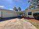 Charming home featuring a two-car garage, palm trees, and well-maintained landscaping at 6118 Roxburg Ave, Orlando, FL 32809