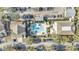 Aerial view showcasing a community pool with lounge chairs, landscaping, and nearby parking at 6593 Queens Borough Ave # 202, Orlando, FL 32835