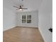 Bright bedroom with a ceiling fan and a view of a window at 6593 Queens Borough Ave # 202, Orlando, FL 32835