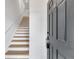 Close up of dark front door with staircase in background at 6593 Queens Borough Ave # 202, Orlando, FL 32835