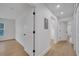Bright hallway with wood floors, white walls, and recessed lighting leading to various rooms at 6593 Queens Borough Ave # 202, Orlando, FL 32835