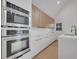 Bright modern kitchen with white cabinets, stainless steel appliances and a sleek black faucet, for seamless cooking experience at 6593 Queens Borough Ave # 202, Orlando, FL 32835
