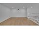Spacious living room featuring hardwood floors, recessed lighting, and white painted walls at 6593 Queens Borough Ave # 202, Orlando, FL 32835