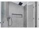 Modern tiled shower featuring a rainfall shower head and glass door at 6593 Queens Borough Ave # 202, Orlando, FL 32835