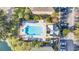 Overhead view of a large rectangular swimming pool with ample lounge chairs and manicured landscaping at 6593 Queens Borough Ave # 202, Orlando, FL 32835