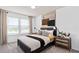 This bedroom features natural light and a black-and-white color scheme at 6736 Reverie Park Ave, Orlando, FL 32829