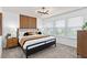Bright bedroom featuring a large window, a modern light fixture, a bed, and tasteful decor at 6736 Reverie Park Ave, Orlando, FL 32829