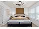 This bedroom features modern decor, a unique headboard, and a stylish light fixture at 6736 Reverie Park Ave, Orlando, FL 32829