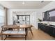 Dining space with a view of the kitchen, showcasing modern appliances and sleek design at 6736 Reverie Park Ave, Orlando, FL 32829