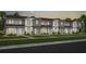A row of newly built townhomes with neat lawns, sidewalks, and similar exterior finishes at 6736 Reverie Park Ave, Orlando, FL 32829