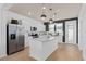 Beautiful kitchen with white cabinets, stainless steel appliances, center island, and stylish pendant lighting at 6736 Reverie Park Ave, Orlando, FL 32829