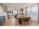 Open-concept living and dining space with natural light, a large sectional, and hardwood floors at 6736 Reverie Park Ave, Orlando, FL 32829