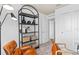 Home office featuring a shelving unit, leather chair, and adjacent doorway at 6736 Reverie Park Ave, Orlando, FL 32829