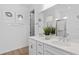 Elegant bathroom featuring double sinks, modern fixtures, and clean white cabinetry at 6744 Willow View Ave, Orlando, FL 32829