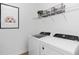 Bright laundry room with modern appliances, shelving, and decorative wall art at 6744 Willow View Ave, Orlando, FL 32829