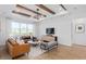 This stunning living room has tray ceilings, gorgeous furniture, and lots of natural light at 6744 Willow View Ave, Orlando, FL 32829