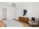 Bright bedroom with a large round mirror, modern chandelier, and a comfortable chair at 6744 Willow View Ave, Orlando, FL 32829