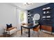 Office space featuring a table with chairs, shelves for storage, and a large window at 6744 Willow View Ave, Orlando, FL 32829