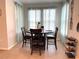 Cozy dining area featuring tile floors and a table set for four with backyard views at 7035 Oxbow Rd, Minneola, FL 34715