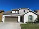 Charming two-story home with stone accents, a well-manicured lawn, and a two-car garage at 7035 Oxbow Rd, Minneola, FL 34715