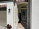 Inviting entryway features a decorative glass front door and stone archway with a welcome sign at 7035 Oxbow Rd, Minneola, FL 34715