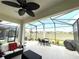 The screened lanai features ample seating, a ceiling fan and expansive views of the neighborhood at 7035 Oxbow Rd, Minneola, FL 34715