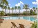 Resort-style pool area with palm trees, lounge chairs, and a relaxing atmosphere for residents to enjoy at 7035 Oxbow Rd, Minneola, FL 34715
