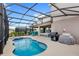 The backyard includes a barbecue, inground pool and dining area perfect for entertaining at 7845 Oak Reflection Loop, Davenport, FL 33837