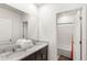 Bathroom featuring double sinks, granite countertops, and a shower in the background at 7845 Oak Reflection Loop, Davenport, FL 33837