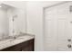 Bathroom with granite countertop, sink, mirror and door to the outside at 7845 Oak Reflection Loop, Davenport, FL 33837