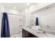 Bright bathroom with a granite-topped vanity and double sinks with a shower and tub combo at 7845 Oak Reflection Loop, Davenport, FL 33837