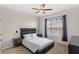 Stylish bedroom with modern furniture, unique geometric wallpaper and a ceiling fan at 7845 Oak Reflection Loop, Davenport, FL 33837