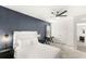 Modern bedroom with a dark accent wall, white furniture, and stylish lighting at 7845 Oak Reflection Loop, Davenport, FL 33837
