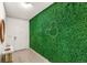 Bright entryway featuring a decorative green wall with Mickey Mouse design, a white door, and a marble-topped table at 7845 Oak Reflection Loop, Davenport, FL 33837