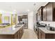 Bright kitchen featuring stainless steel appliances, granite countertops, and an island with bar seating at 7845 Oak Reflection Loop, Davenport, FL 33837