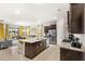 Open-concept kitchen and dining area with stainless steel appliances and granite countertops at 7845 Oak Reflection Loop, Davenport, FL 33837