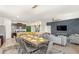 Open-concept living space with a dining area, kitchen island, and a living room with stylish furnishings and decor at 7845 Oak Reflection Loop, Davenport, FL 33837