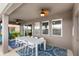 Covered patio featuring an outdoor dining area with ceiling fans and patterned rug at 7845 Oak Reflection Loop, Davenport, FL 33837