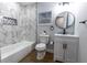 Elegant bathroom with marble-patterned walls, a modern vanity, and a sleek bathtub for a luxurious feel at 812 S Locust Ave, Sanford, FL 32771