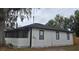 Charming single-story home with screened-in porch, crisp white siding, and black trim at 812 S Locust Ave, Sanford, FL 32771