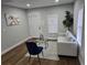 Cozy living room featuring hardwood floors, a comfortable sofa, and a stylish glass coffee table at 812 S Locust Ave, Sanford, FL 32771
