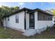 Side exterior of home with a screened-in porch and an entry door at 812 S Locust Ave, Sanford, FL 32771
