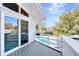Balcony with gray decking overlooking a pool and backyard with mature trees at 8922 Bay Cove Ct, Orlando, FL 32819