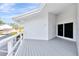 Private outdoor balcony featuring modern white railing and gray flooring at 8922 Bay Cove Ct, Orlando, FL 32819