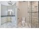 Modern bathroom featuring marble tiled floors, shower, toilet and vanity at 8922 Bay Cove Ct, Orlando, FL 32819